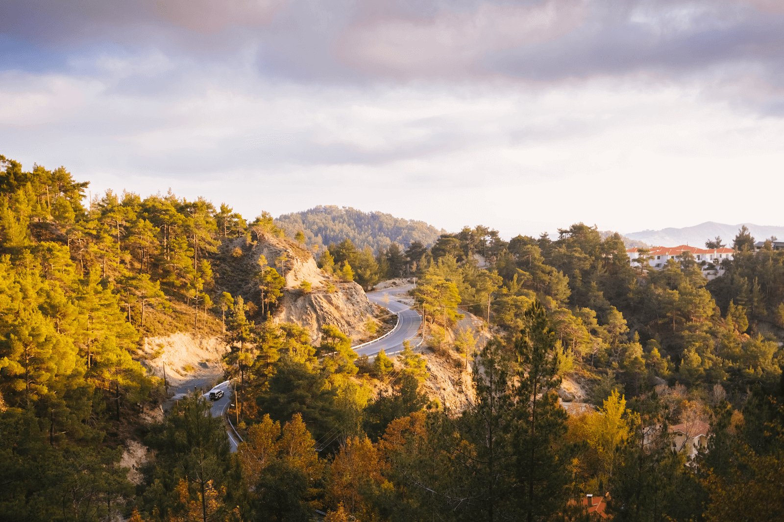 Many Trips in the Life of a Digital Nomad:A Rural Location With A Car Driving Among Many Hills Full Of Trees